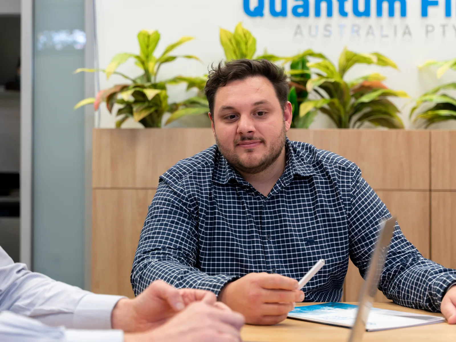 A Quantum Finance broker going through documents with clients at the West Leederville office
