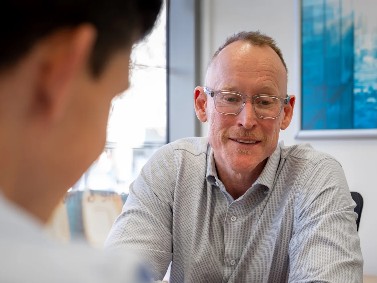 A Quantum Finance broker talking through a client's position at the West Leederville office