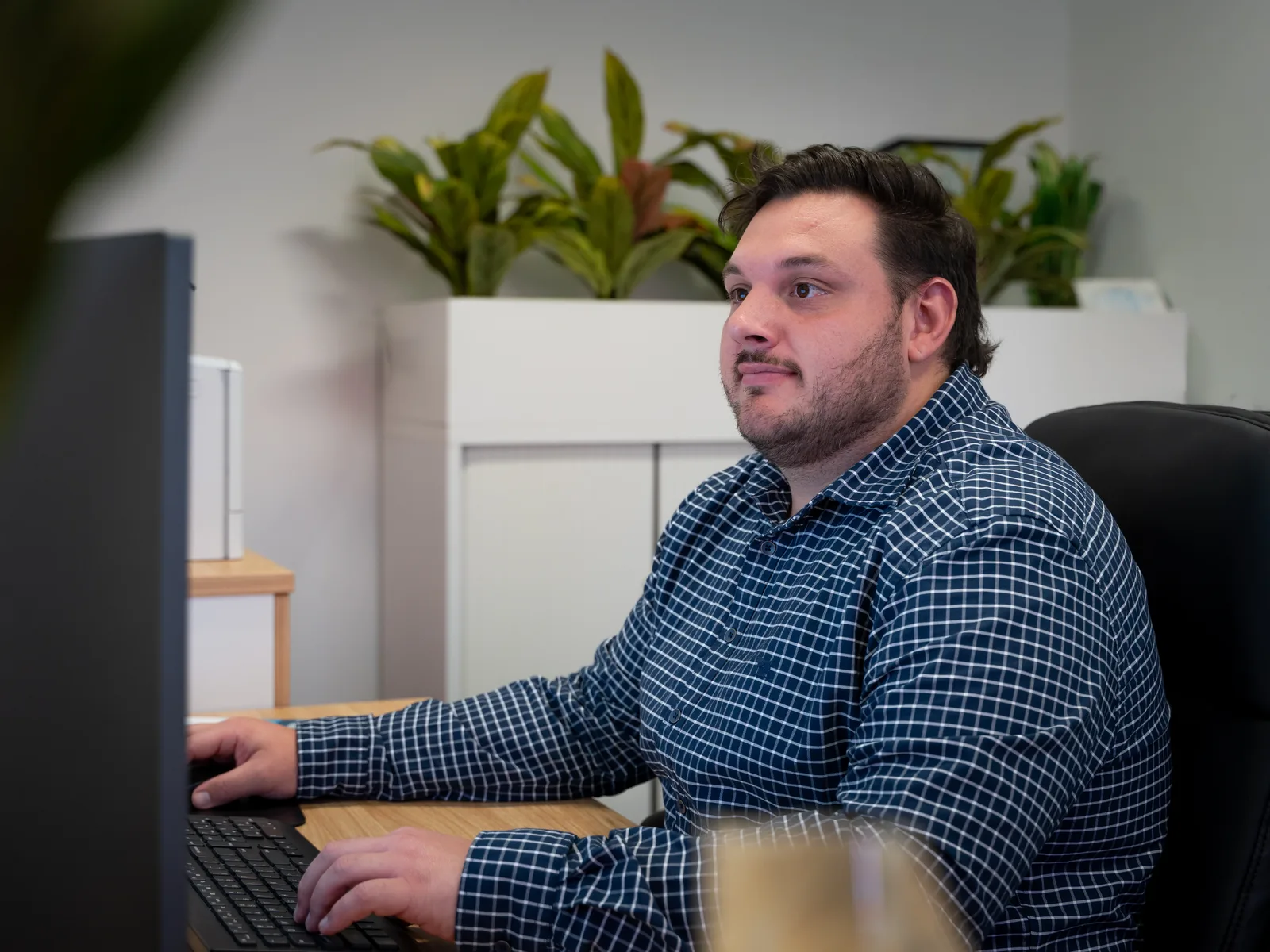 A Quantum Finance broker reviewing an application on screen at the West Leederville office